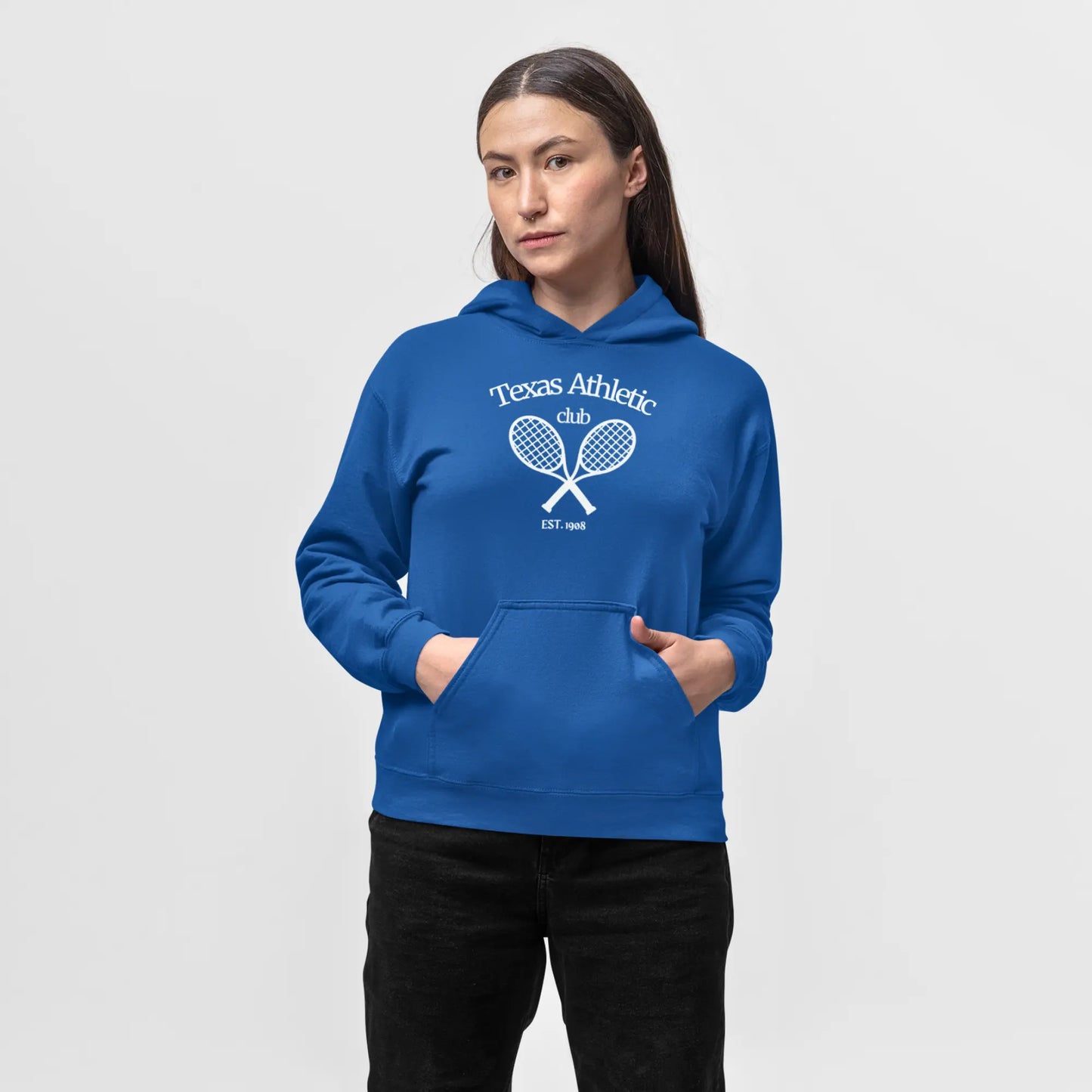 Woman in a royal blue hoodie with 'Texas Athletic Club EST. 1985' and crossed tennis rackets graphic on the front.