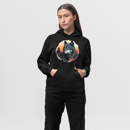A woman stands wearing a black hoodie with a central graphic print featuring a detailed, colorful wolf illustration set against a backdrop of pine trees and an orange and yellow sunset circle.