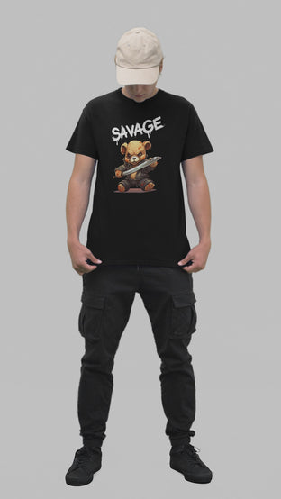 A young man in a black t-shirt featuring the word 'SAVAGE' in white dripping letters, with a graphic of a battle-ready teddy bear below.